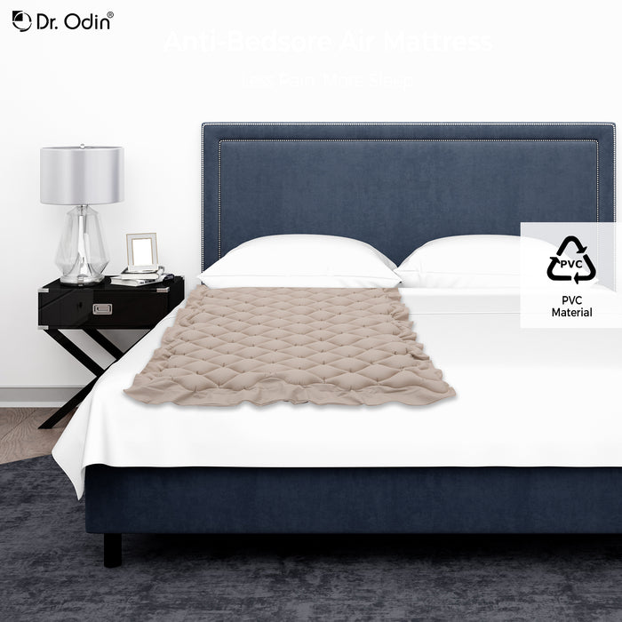 Bed with beige comforter and dark blue headboard, nightstand with lamp on a white background, Dr. Odin brand visible.