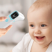 Baby being measured with a digital thermometer, with a blurred background