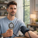 Man taking his blood pressure at home using a digital blood pressure monitor.