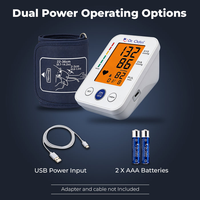 Blood pressure monitor with USB power input, batteries, and adapter on a dark background